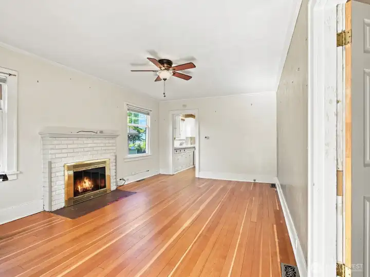 Stunning hardwood floors provide warmth to the space as natural light fills the home through the abundance of windows throughout.