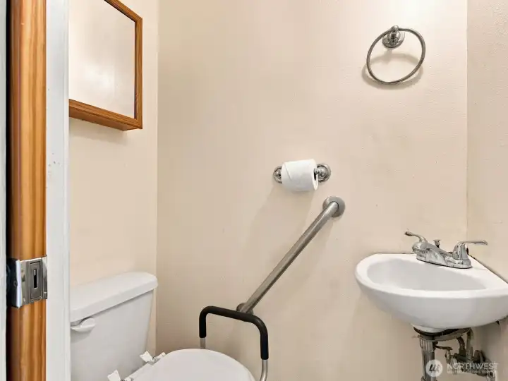 The bathroom is separated. The toilet with a sink is on one side of the hall and the tub/shower and vanity are on the other.