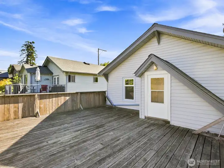 Out back is an oversized deck over the garage.