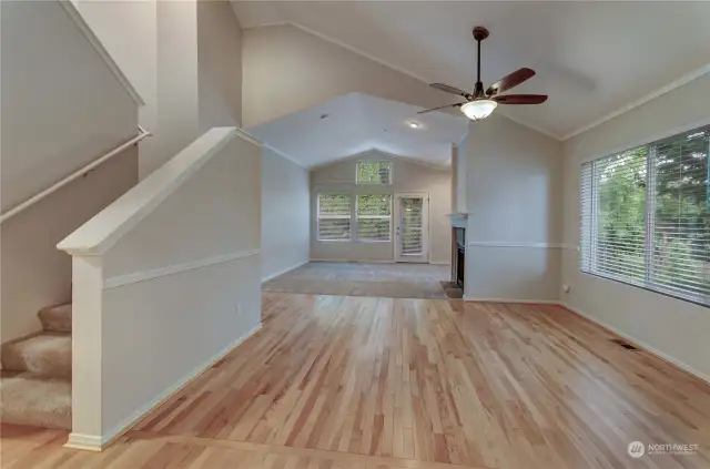 Hardwood extends from entry into the kitchen and out here to the dining space and into the Main Floor Primary Bedroom.