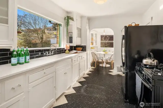 Original kitchen with new counter and tile. Keep it as it is or use the large space to create your own idea of the perfect kitchen. It's got the space you need!