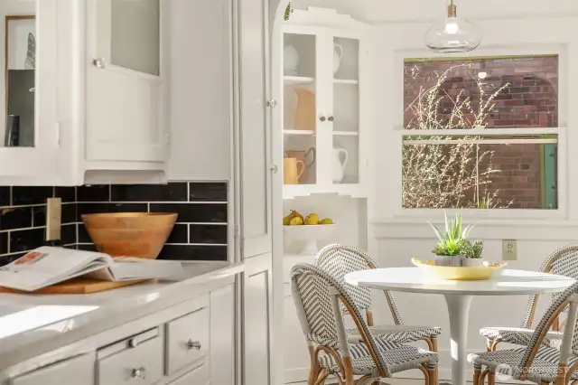 Look at that charming kitchen nook with original built in cabinets.