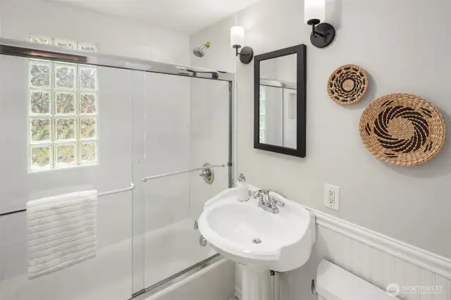 Freshly painted and beautiful second bathroom with glass brick to bring the light in while keeping things private!