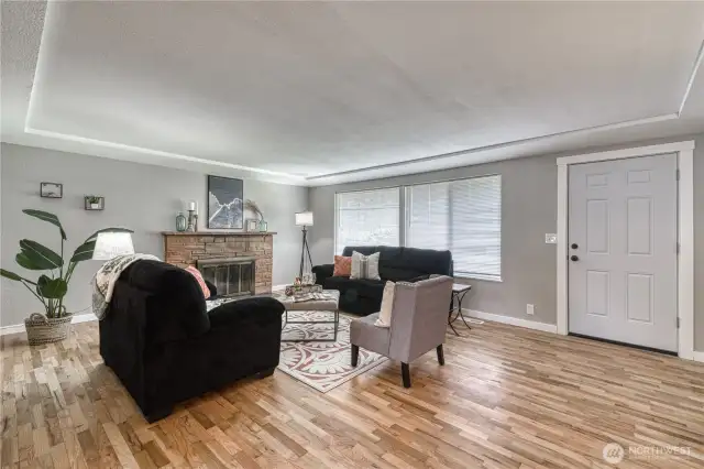 Inside you will find refinished hardwoods and fresh interior paint.  Here is a look at the living room with wood burning fireplace.
