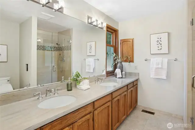 Updated primary bathroom with elegant double vanities