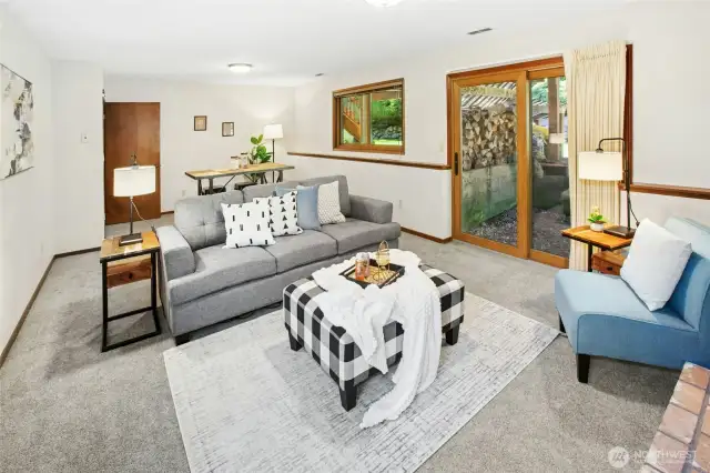 Another angle of the bonus room featuring a charming wood stove fireplace