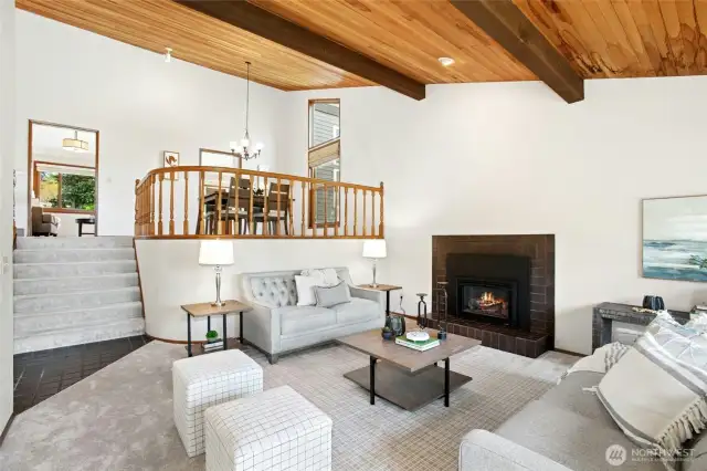 Another angle of the living room showcasing vaulted ceilings