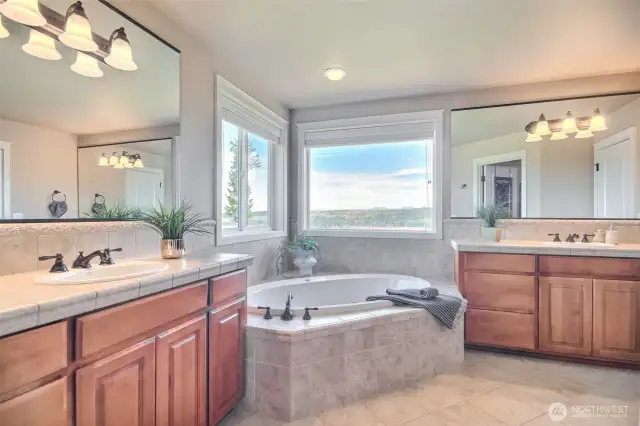 Primary bathroom with double sinks and jetted tub.