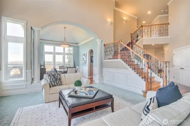 Elegant living room. Custom wrought iron stairs case and formal dining room with incredible views.