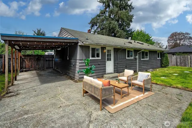 Back yard patio with carport area