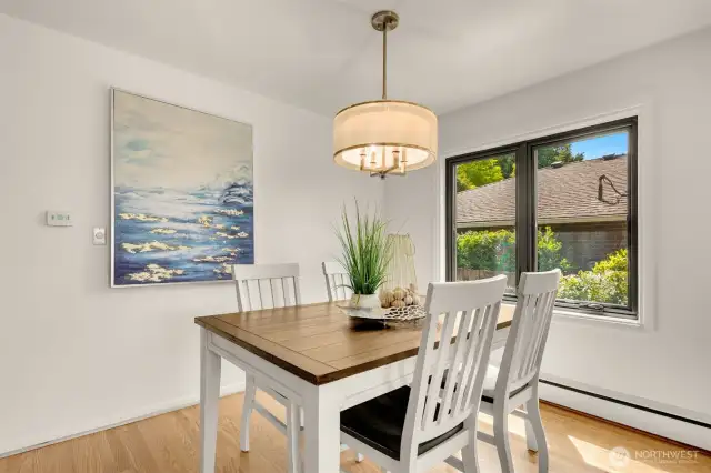 A great space for entertaining and intimate meals. A kitchen pass-through behind artwork.