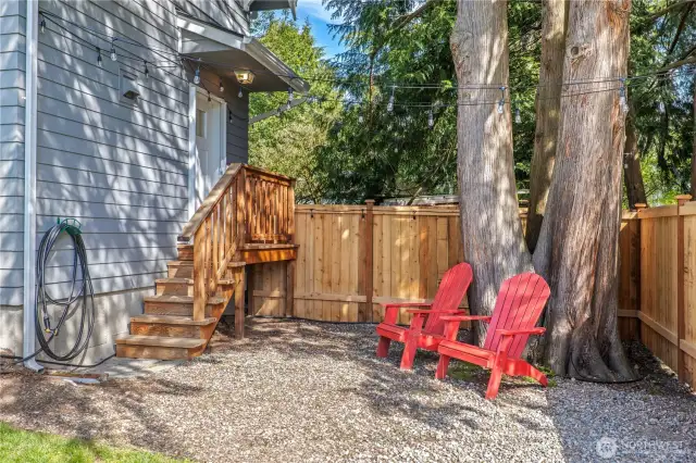 This sweet space just outside the back door (off of the kitchen) gives you a great shady space to relax with a good book, maybe a fire pit?