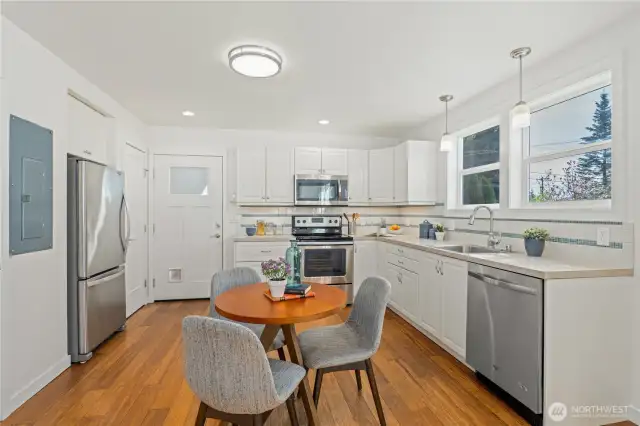 The kitchen is open and bright, with room for both a dining set and an island!