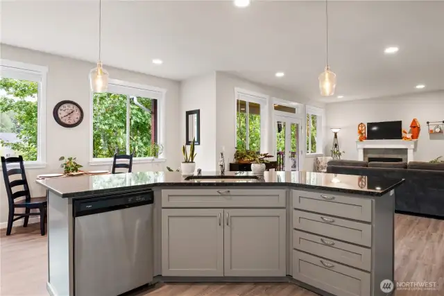 Storage and dishwasher with sink on the island. Open living with views of the dining space and living room with lots of windows and French Doors for natural light.