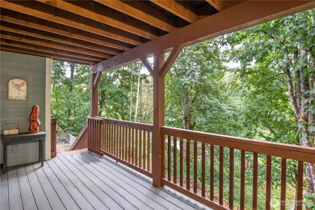 Lower floor deck with stairs to fenced back yard.