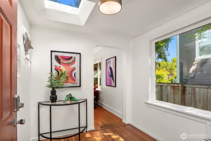 Entryway with skylight and large window.