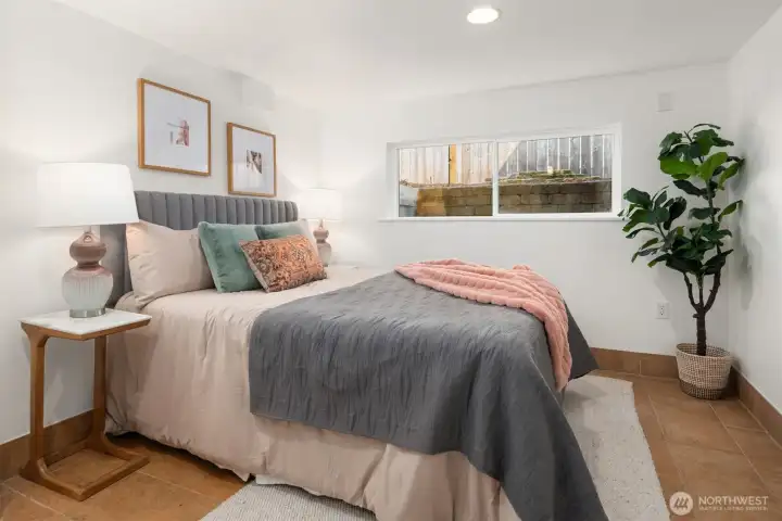 Bedroom with tile flooring and wide window