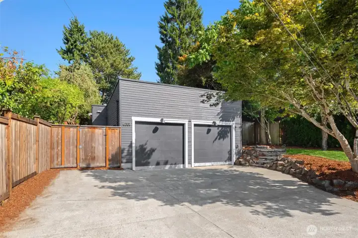 View of driveway and double garage doors.