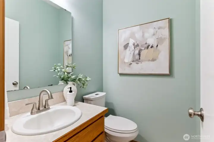 Updated half bath on the main floor includes new hardwood floors and paint.