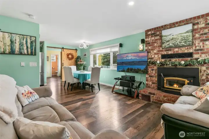 Living room with wood burning fireplace (with fan).