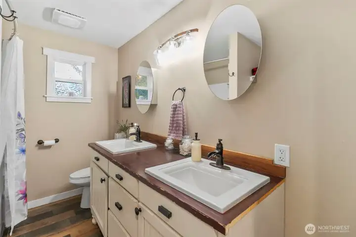 Main bathroom with tub/shower, toilet, double sink and linen storage (not in picture)
