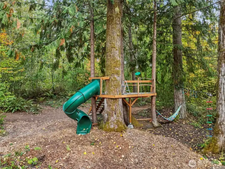 Forest fort with 150' zipline, tube slide, hammock and ninja line.
