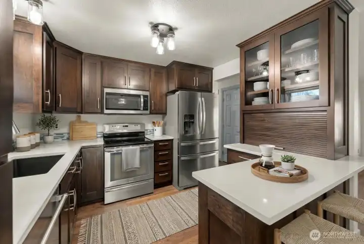 Gourmet kitchen with abundance of custom cabinets, quartz coutertops and stainless steel appliances