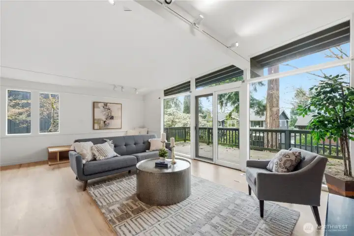 Expansive wall of windows opens to a large composite deck—perfect for entertaining, relaxing, and enjoying peaceful, private surroundings.