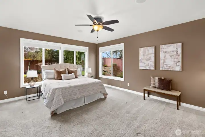 Generously sized primary suite tucked at the end of the house for relaxation and private enjoyment!