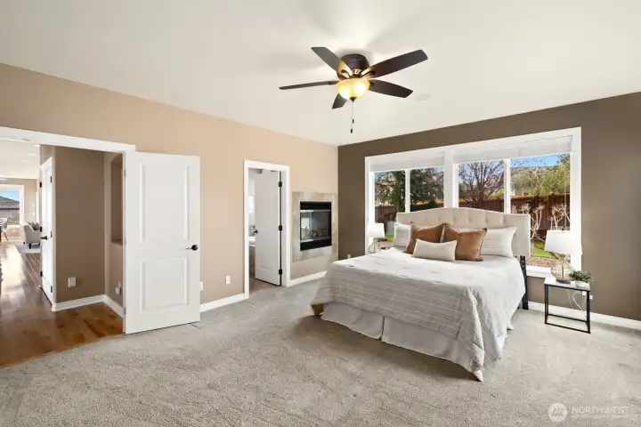 Primary suite with see through fireplace to primary bathroom.