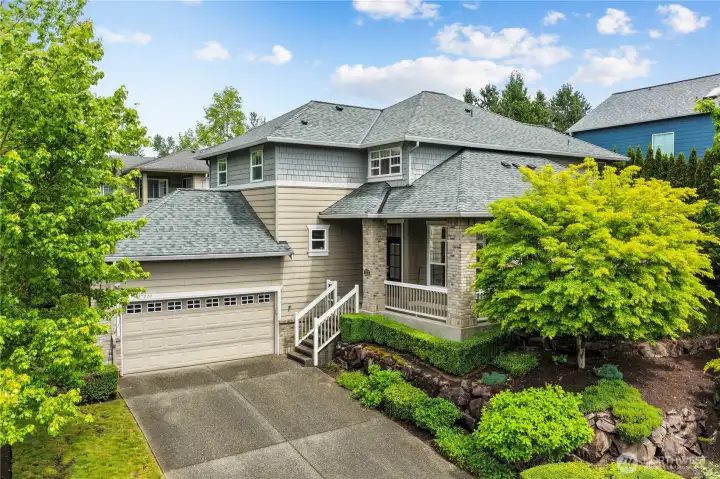 Beautiful corner lot surrounded by mature low maintenance landscaping