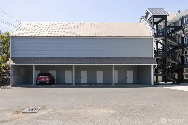 Covered parking spot is furthest left spot in picture.