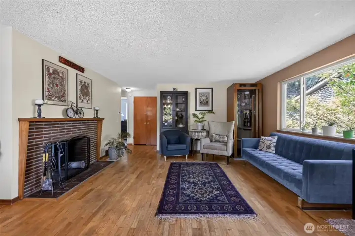 Cozy living room with wood-burning fireplace, phone booth is decor and does not stay