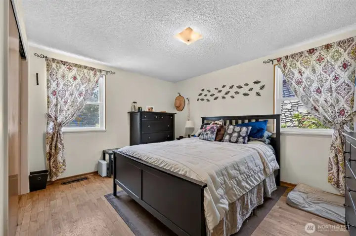 Sunny primary bedroom on the main level