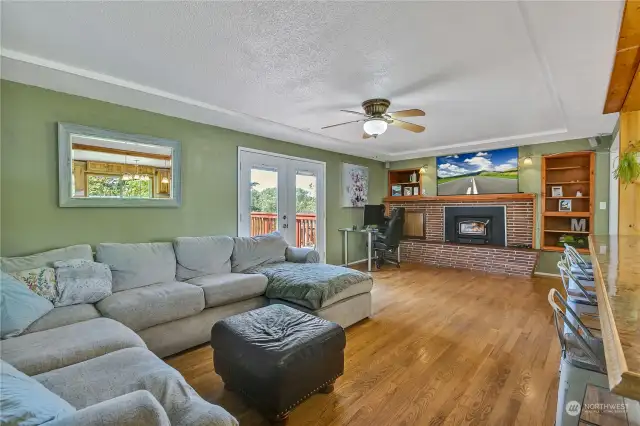 Great Room with doors leading to beautiful deck overlooking the park like backyard.