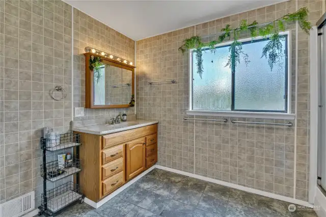 Large Full bath with extensive tile work located upstairs with access to all 3 bedrooms.