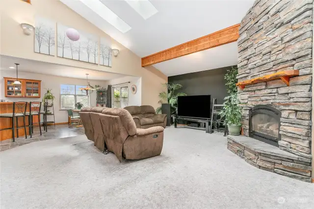 Open floor space anchored by a beautiful fireplace.