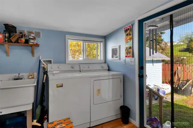 Heated, bright and insulated mud/laundry room addition at rear of home.