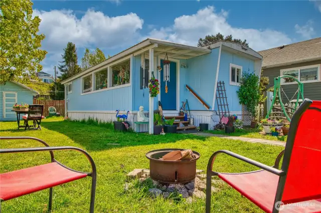level lawned yard with fire pit.