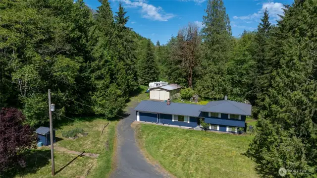 Beautiful home with fresh paint, newer metal roof surrounded by trees with a stream in the backyard!!!
