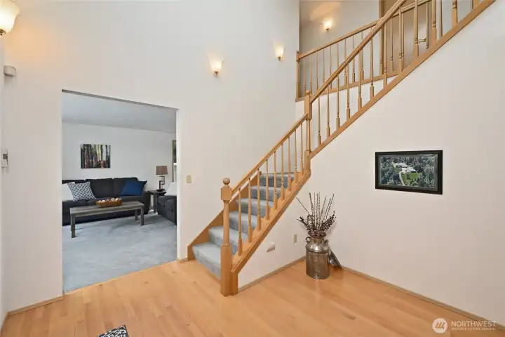 Light and bright spacious entry has vaulted ceiling, skylight and hardwoods
