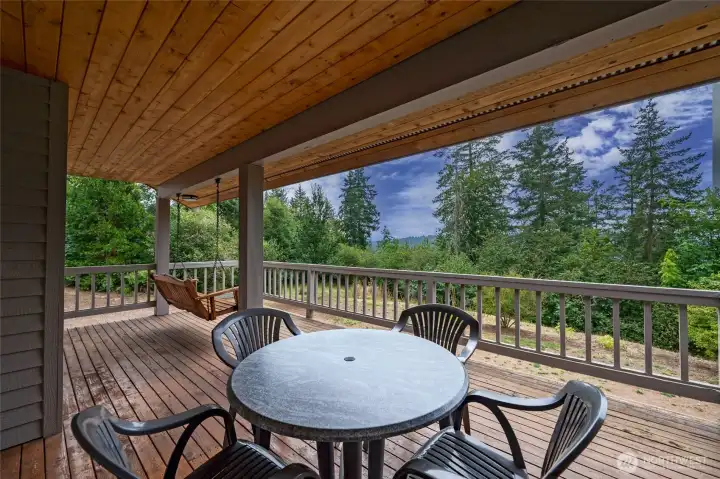 Covered deck and built-in swing to stay dry and enjoy the sunset views or deer grazing