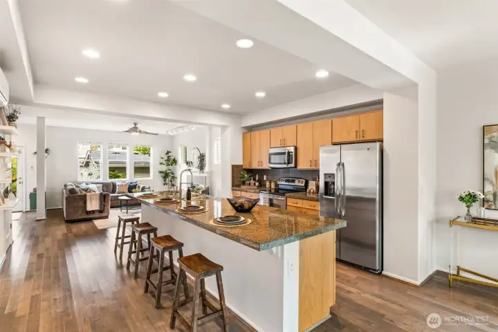 Beautiful hardwood floors flow seamlessly through a layout designed for gatherings.