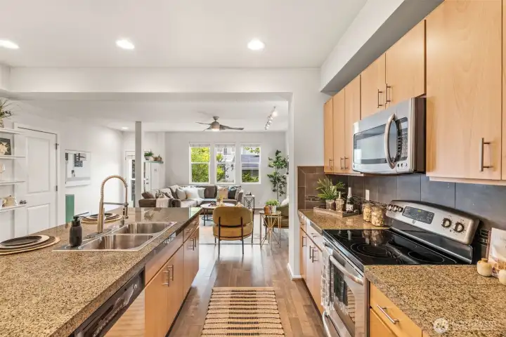 Your open kitchen boasts stainless appliances, granite counters and a 12 foot kitchen island with breakfast bar.