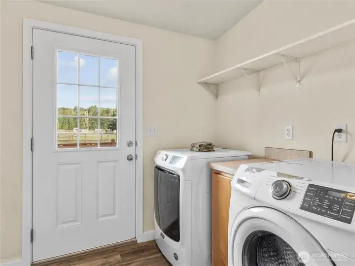 Dedicated laundry room with door leading to back deck