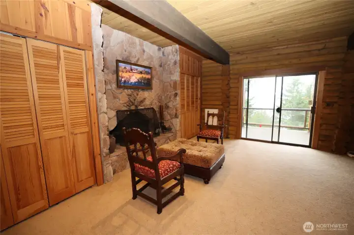 Primary Bedroom complete with a fireplace and doors to the lower deck