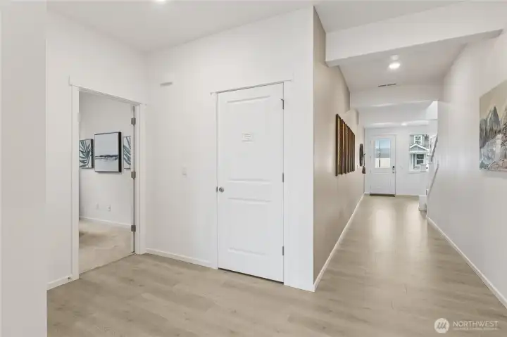 Wide hallway leading you to the downstairs bedroom.   Pictures are for representational purposes only, colors and features may vary.