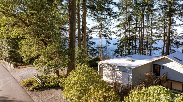 The expansive double lot features a fenced and landscaped front with a secluded Deck