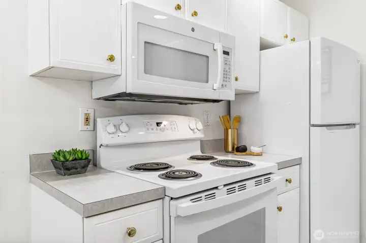 A sleek, modern kitchen awaits with stainless steel appliances, ample cabinetry, and beautiful countertops.