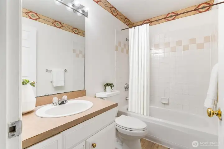 This beautifully designed full bath offers a spa-like retreat with elegant finishes and a deep soaking tub.